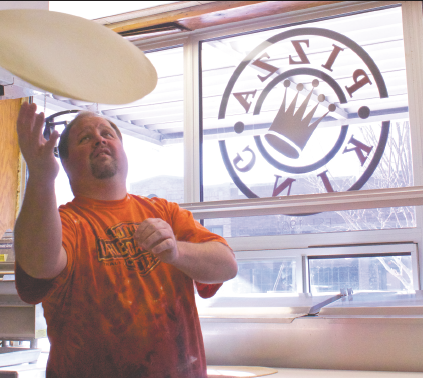 Shannon Brown, owner of Pizza King, tosses his homemade dough when making an order. Brown also makes his own sauce fresh daily.