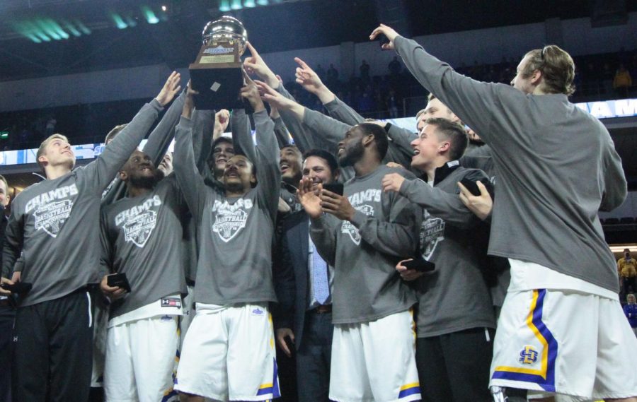 The SDSU men's basketball team hoists the Summit League Championship trophy. The Jacks topped NDSU 67-59 in the title game Tuesday night. 
