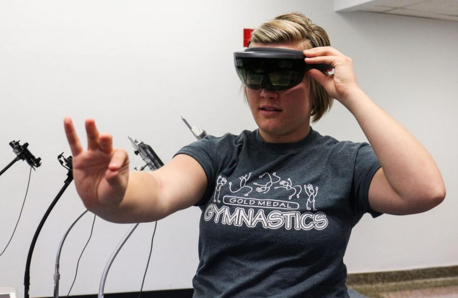 Alex Cooley, senior early childhood education major and student employee at Instructional Design Services, demonstrates how to use the Microsoft HoloLens seen here.