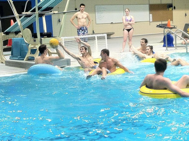 Its important to mix up your exercise routine. These students play intramural inner tube water polo in the Wellness Center pool. 