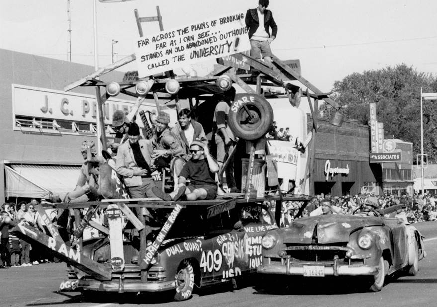 Digital Library of South Dakota (DLSD)
A float rides through the parade during Hobo Day (1963). This was the tipping point for Hobo Day floats, as regional newspapers would criticize SDSU students for being “vulgar” and “obscene,” resulting in administration toning down future floats. 