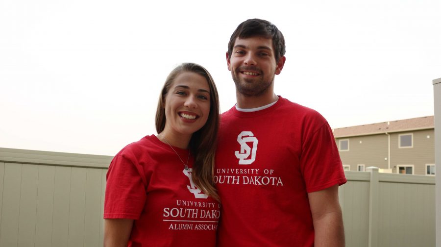 IAN+LACK%0AArianne+Aasen+and+Casson+Dennison+wear+T-shirts+the+University+of+South+Dakota+Alumni+Association+sent+them+to+commemorate+their+engagement+and+acknowledge+the+SDSU-USD+rivalry.+On+the+back%2C+Dennison%E2%80%99s+reads%2C+%E2%80%9CI+love+a+Coyote%2C%E2%80%9D+while+Aasen%E2%80%99s+reads%2C+%E2%80%9COnce+a+Coyote%2C+Always+a+Coyote.%E2%80%9D