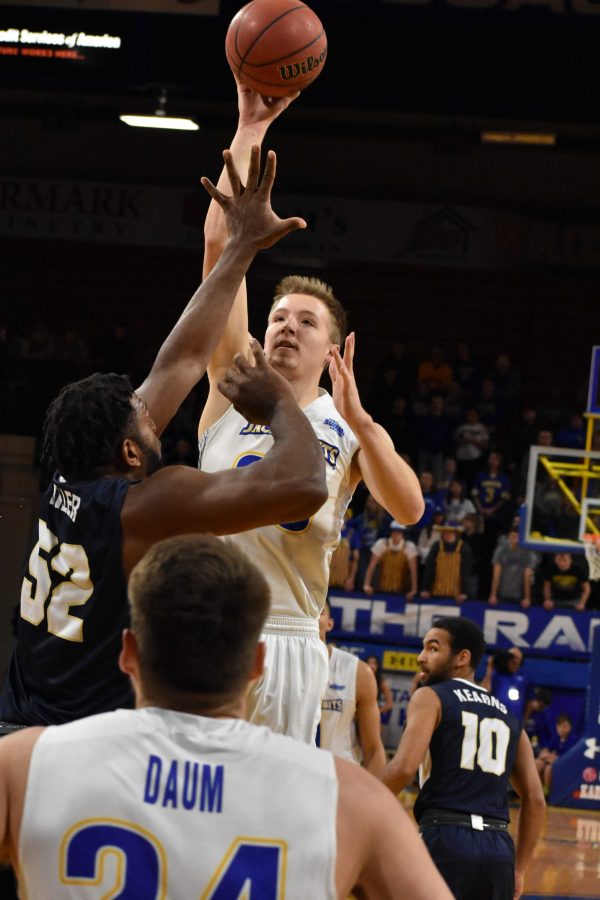 Senior forward guard Reed Tellinghuisen (23) takes a jump shot over Oral Roberts forward Chris Miller (52) during the first half of the game Thursday, Jan. 11. The Jacks beat the Golden Eagles 78-73.