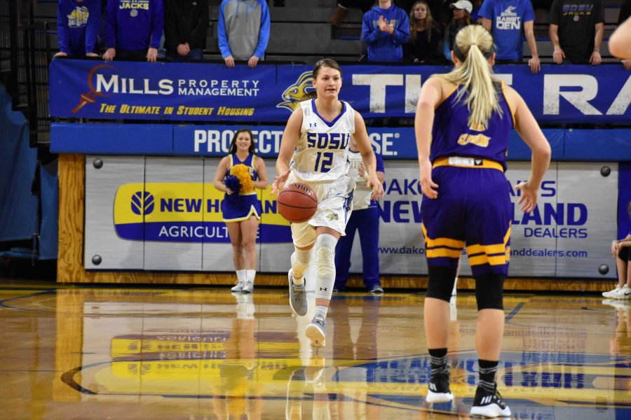 ABBY FULLENKAMP
Redshirt junior guard Macy Miller (12) drives the ball down the court during the first half of the game against Western Illinois Saturday, Jan. 20. SDSU won 84-48. 