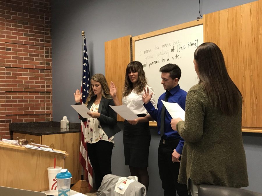 EMILY DE WAARD
(Left to right) Allison Pauley, Baylee Dittman and Ryan Sailors swearing in as At-Large senators at the Jan. 29 Students' Association meeting.
