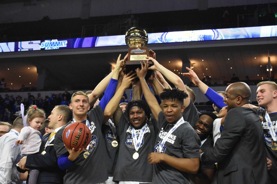 ABBY FULLENKAMP Beau Brown, David Jenkins Jr. and Brandon Key hold the Summit League Championship trophy on March 6. SDSU defeated USD 97-87. 