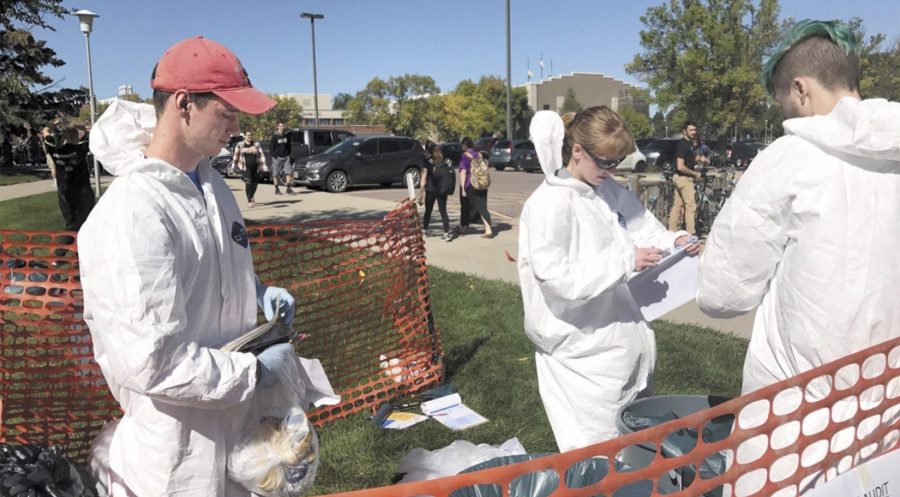 MACKENZIE HUBER
Sustainability Specialist Jennifer McLaughlin, Sustainability Council President Kory Heier and Dylan Lewark, freshman computer science major, sort trash for a waste audit in front of The Union Sept. 20.