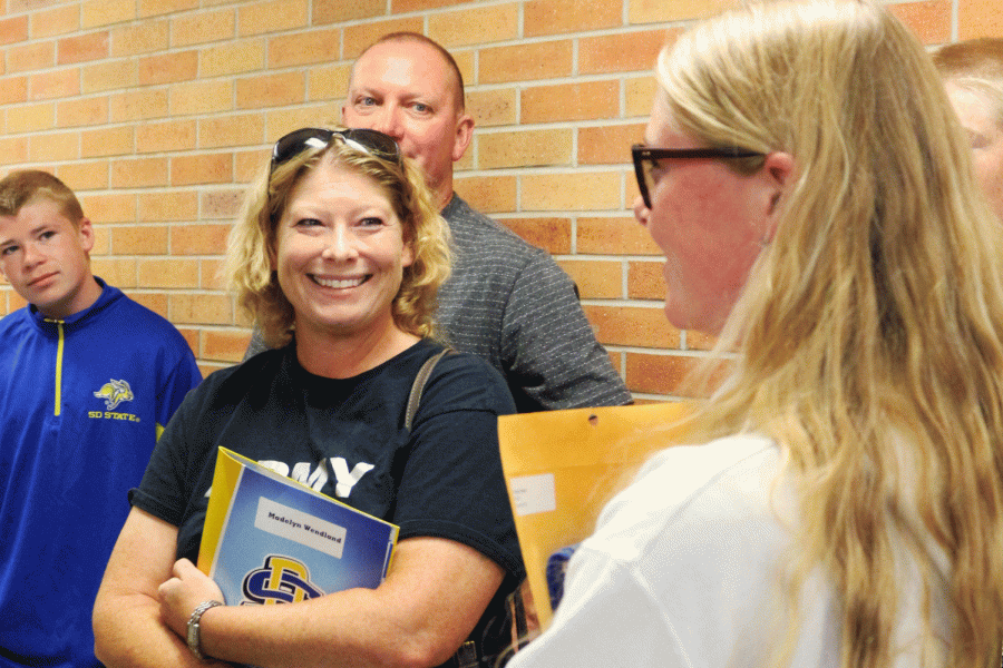 Madelyn Wendland and her parents talk while moving in Friday, August 23. 