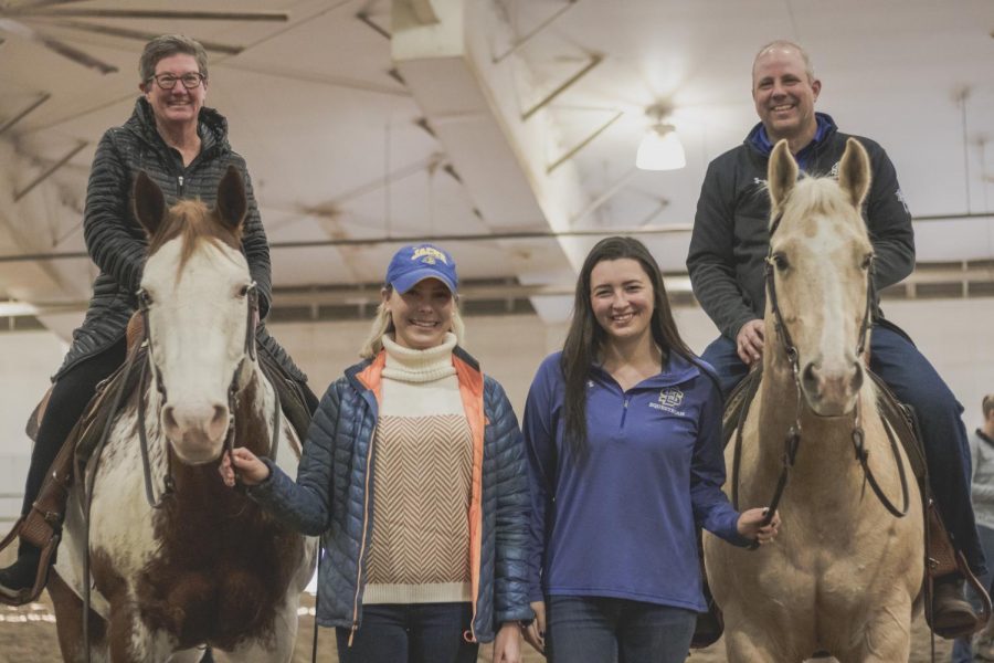 Kathy Heylens -Senior Associate AD-Compliance/SWA and Justin Sell -Director of Athletics posing with Marielle Golden - Jumping Seat Coach and Morgan DiGiulio - Western Coach during the athletics staff riding event at the DeHaan Equestrian Center on Friday, Nov. 15. 
