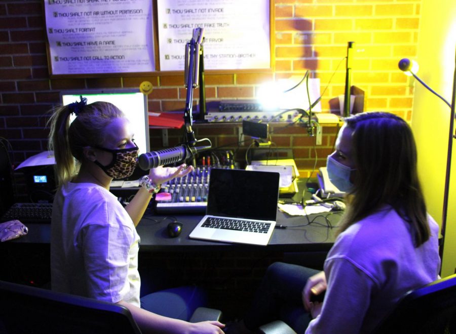 KSDJ radio station manager Tori Berndt, left, talks with her co-host Megan Janssen about their shows content at 7 a.m. in the University Student Union, Lower level.