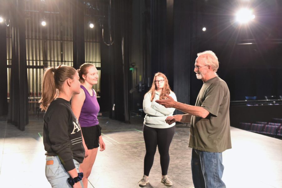 Students in musical Carrie discuss show details with director John Ackman.
