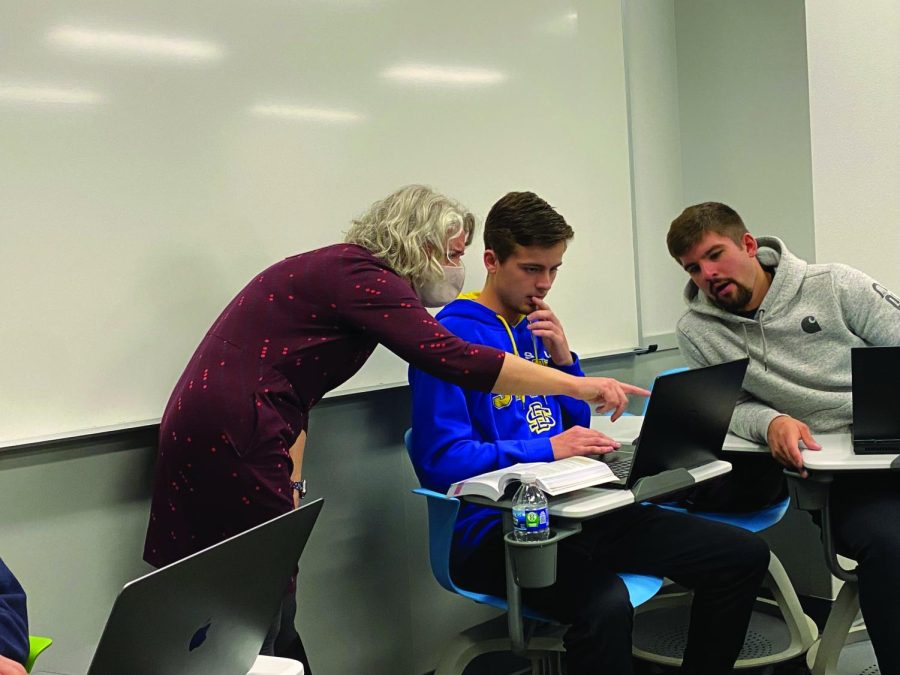 Nicole Flynn assists some of her students during one of her classes. Apart from teaching, Flynn has been involved with English Club, the faculty council and research projects at SDSU.