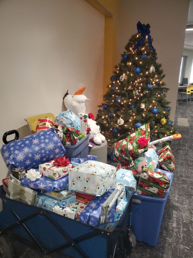 %E2%80%8B%E2%80%8BStacks+of+donated+and+wrapped+toys+sit+in+the+Multicultural+Center+waiting+to+be+given+to+children+and+families.