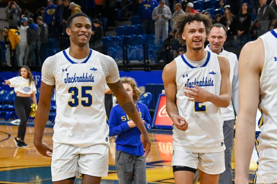 Senior Douglas Wilson and freshman Zeke Mayo celebrate after their win over Omaha Saturday afternoon. Mayo had a career high 21 points, shooting 5-8 from three-point range. Wilson had 19 points in the victory. Wilson will play his final two games at Frost Arena this week.
