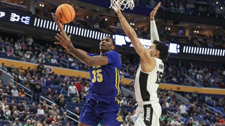 Jacks forward Douglas Wilson goes for a layup on Providences Justin Minaya in a first-round NCAA Tournament game Thursday. Wilson scored 13 points in the final game of his Jackrabbit career as his team suffered a 66-57 loss to the Friars.