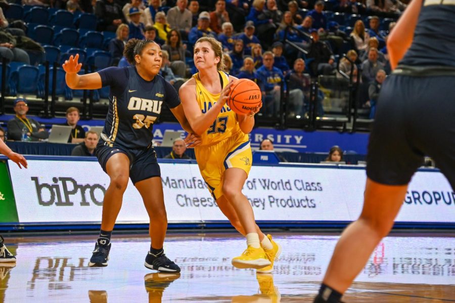 South Dakota State’s Paiton Burckhard drives on Oral Roberts’ Trinity Moore in a Summit League game last Saturday. The Jacks open Summit League tournament play this Saturday at 12:30 pm at the Denny Sanford Premier Center.