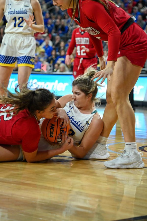 Paiton Burkhard fights for the ball with Kyah Watson in the Summit League Tournament championship game Tuesday afternoon at the Denny Sanford PREMIER Center. Burckhard had 15 points in the Jacks loss.