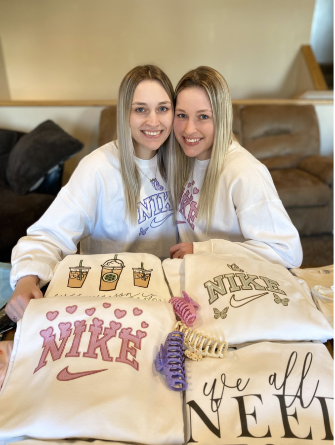 Ashley and Keeley Fischbach sitting with their boutique products