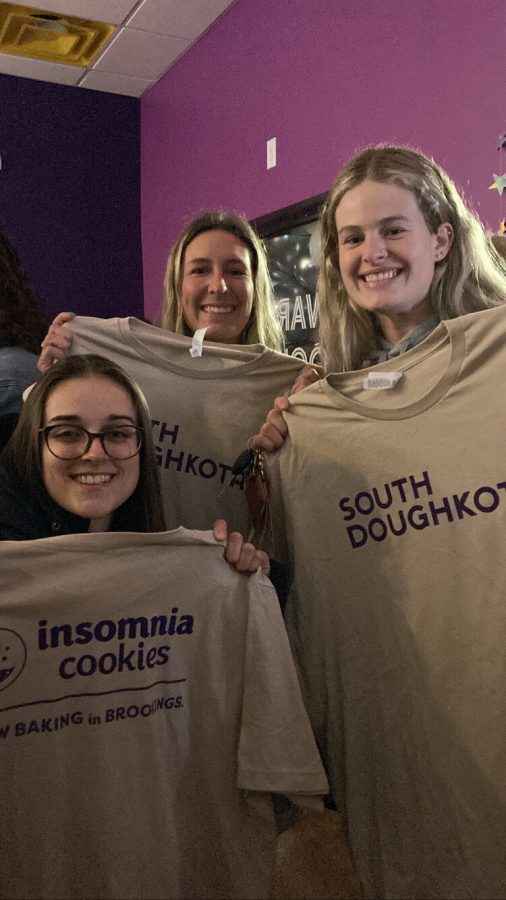 Members of the softball team, Chiara Bassi, Allison Yoder and Shannon Lacey recieved “South Doughkota” t-shirts at the Jan. 14 grand opening of Insomnia Cookies.  