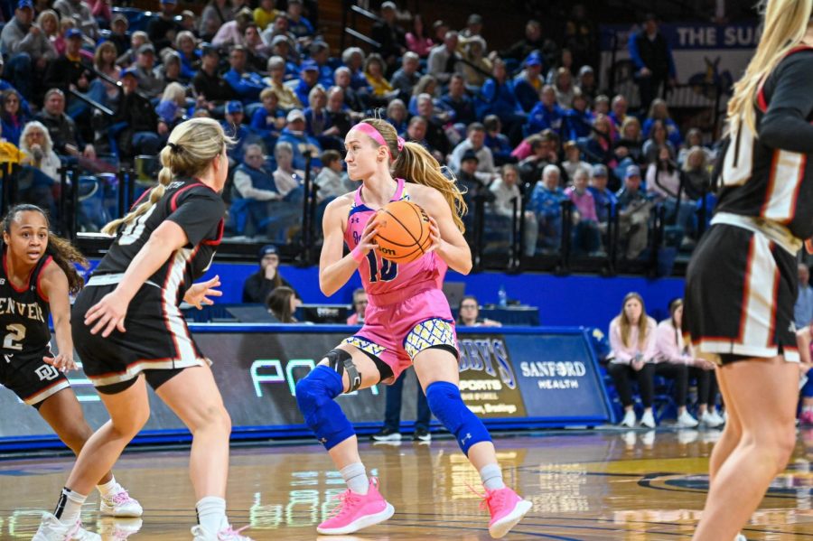 Jackrabbit guard Dru Gylten looks to pass the ball on Denvers Emma Smith in SDSUs 82-34 win over the Pioneers Feb. 16. 