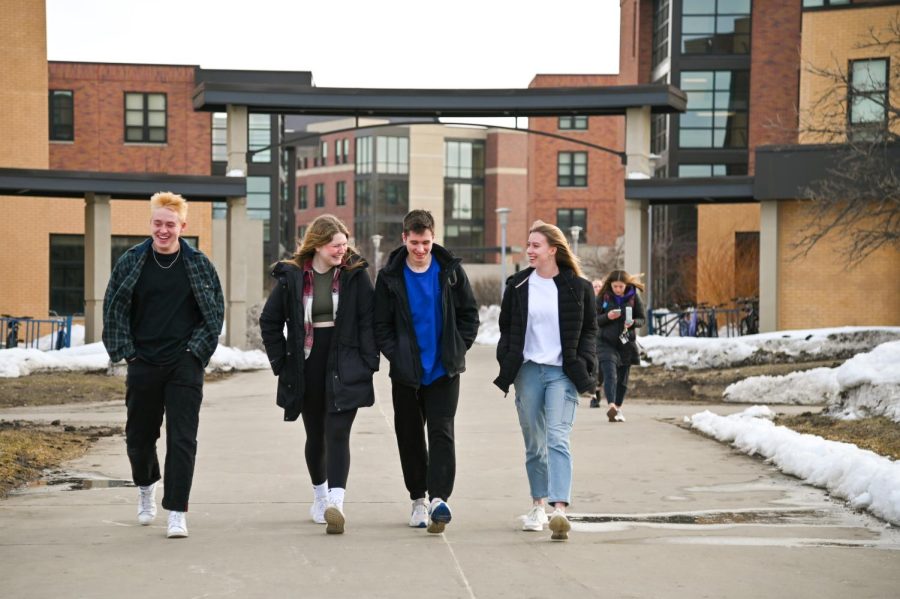Group Of Students Walking Campus
