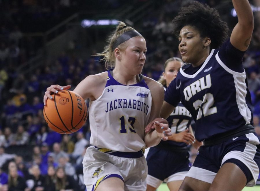 Jackrabbit guard Haleigh Timmer drives on ORUs Tirzah Moore in a Summit League Tournament semifinal game March 6 at the Denny Sanford Premier Center in Sioux Falls.