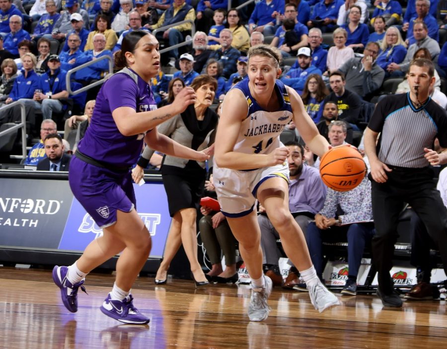 Jackrabbit forward Myah Selland drives the ball on St. Thomas Autam Mendez March 4 in the Summit League Tournament at the Denny Sanford Premier Center in Sioux Falls.