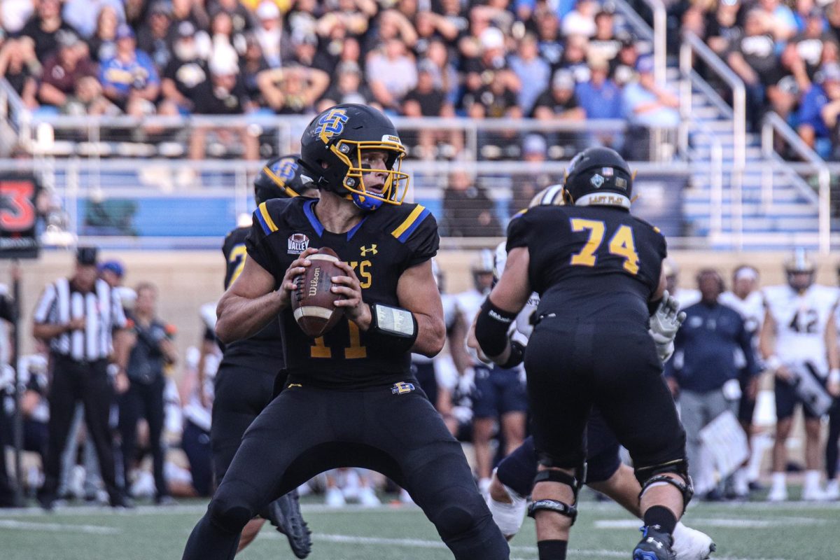 Mark Gronowski (11) drops back to pass during a football game against Montana State at Dana J. Dykhouse Stadium in Brookings, S.D. on Saturday, Sept. 9.