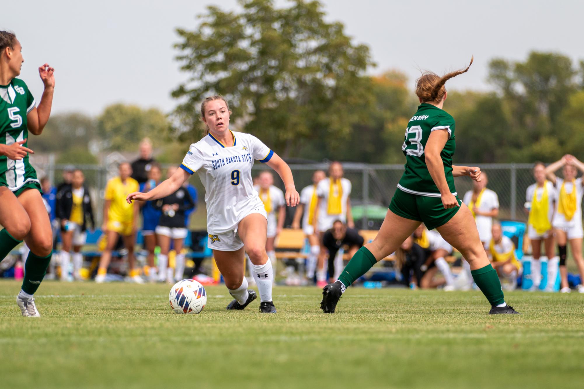 Katelyn Beulke (9) dribbles between two Green Bay defenders in a soccer match at Fishback Soccer Park in Brookings Sunday, Sept. 10, 2023.