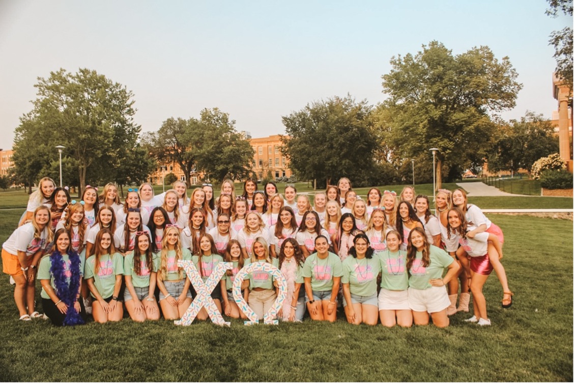 Members of Chi Omega posing for a group photo  here on campus on bid day 2023.