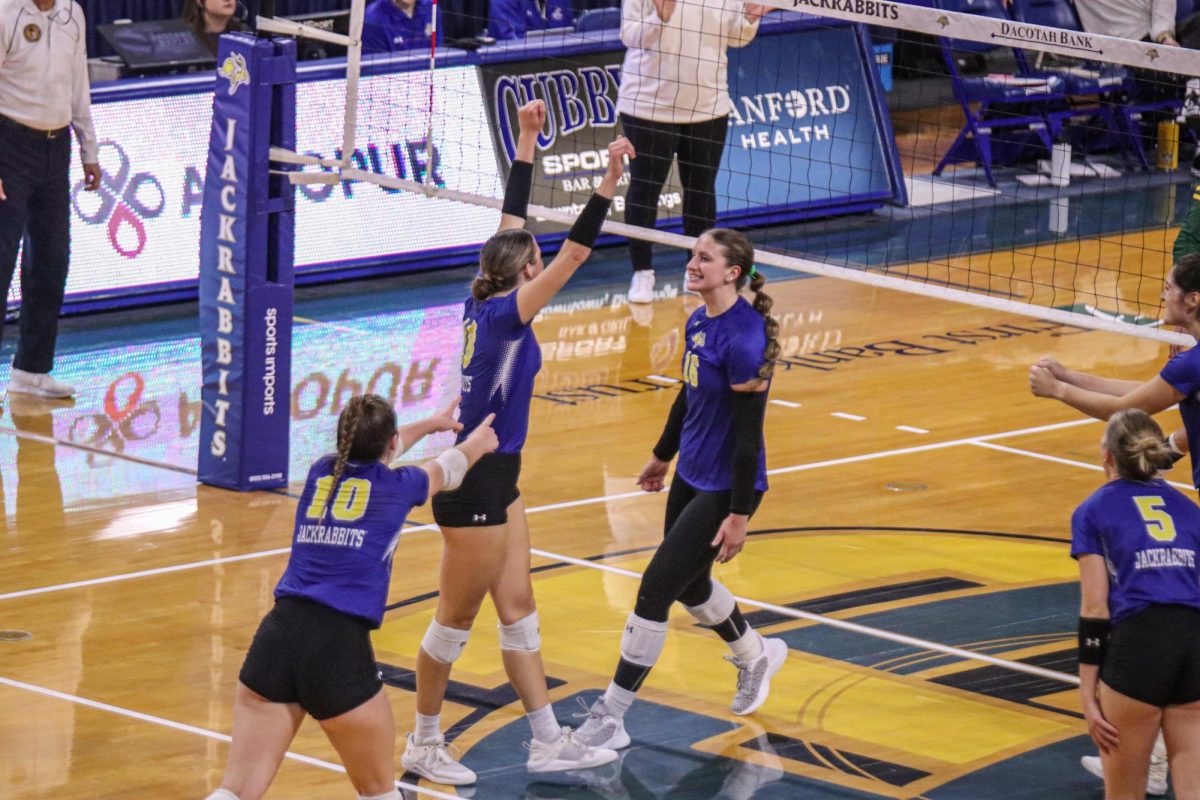 Sylvie Zgonc (#10), Elyse Winter (#18) and Katie Van Egdom (#16) celebrite a point scored in their home match against NDSU.