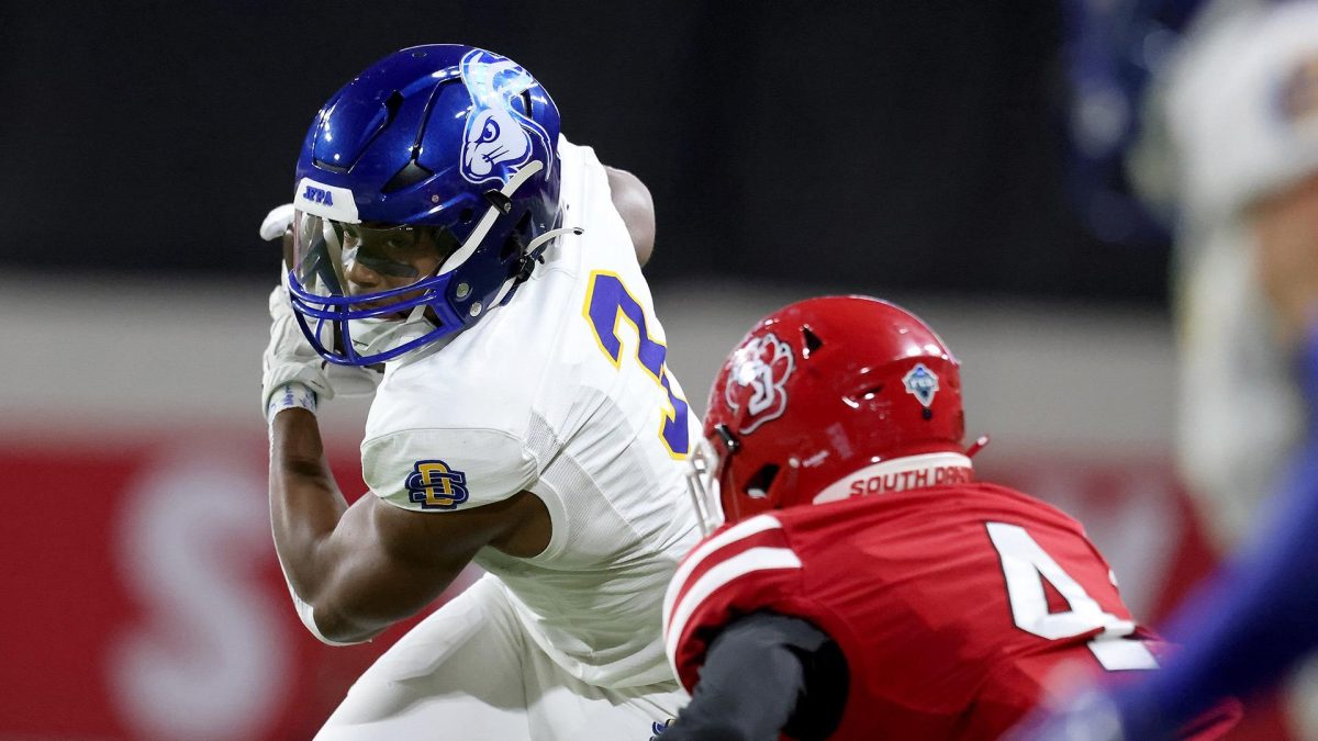 South Dakota State running back Amar Johnson (3) looks to make a move past South Dakotas Shahid Barros (4) during their game at the DakotaDome Saturday, October 28, 2023 in Vermillion, S.D. 