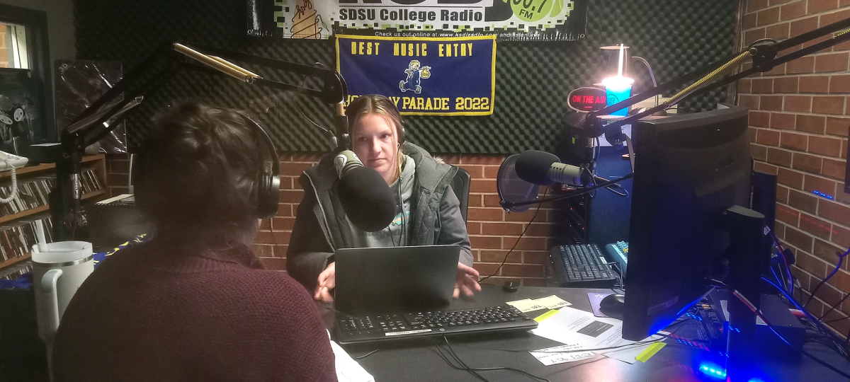 Catherine Jones and Samanth Richert host a halloween special podcast at the KSDJ Radio station located in the University Student Union basement Tuesday, Oct. 31, 2023.
