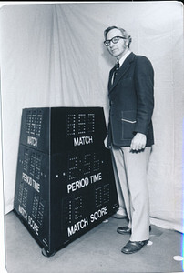Al Kurtenbach, early in his career, standing next to one of his scoreboards.