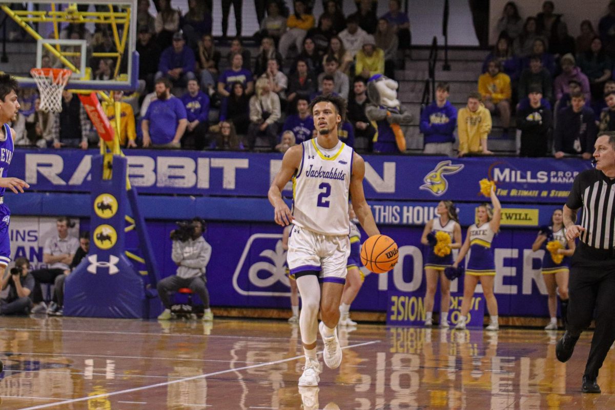 Jackrabbit+guard+Zeke+Mayo+takes+the+ball+up+the+court+in+the+team%E2%80%99s+83-55+victory+against+Dakota+Wesleyan+Nov.+8.+Mayo+has+scored+129+points%2C+dished+out+24+assists+and+grabbed+52+rebounds+on+the+year.
