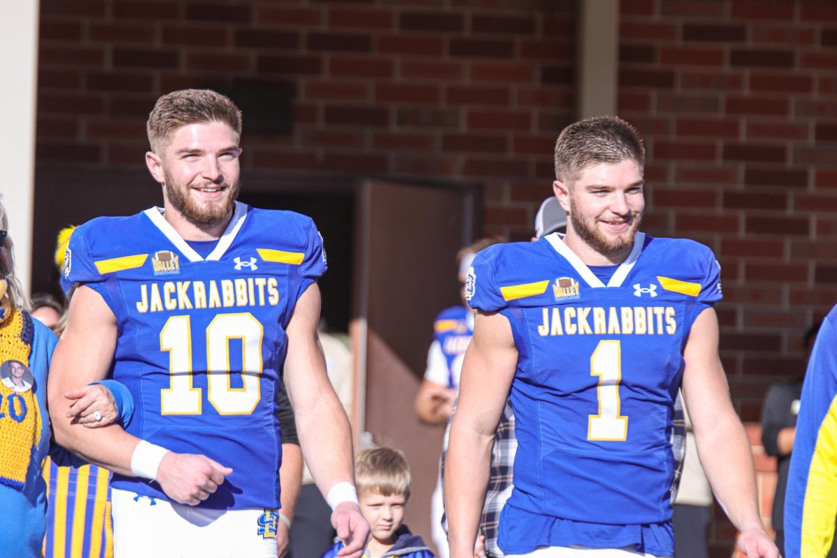 Jaxon (10) and Jadon (1) walk with their parents during a celebration honoring the seniors on the football team before their game against Missouri State at Dana J. Dykhouse Stadium in Brookings Saturday, Nov. 18, 2023.