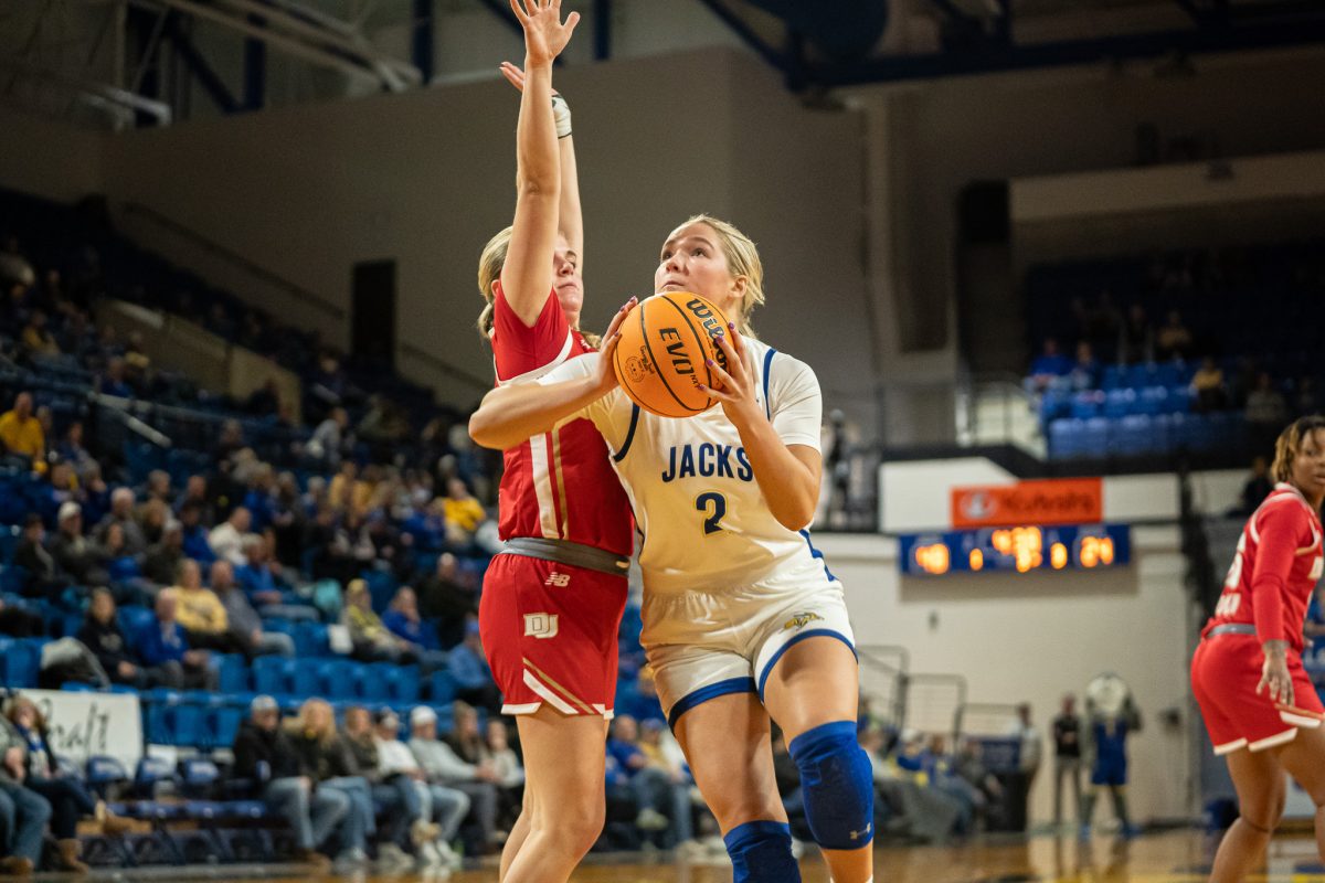 Jenna Hopp drives to the basket against Denver defender in their win. Hopp shot 5-8 on the night and finished with 12 points, two assists and two rebounds.