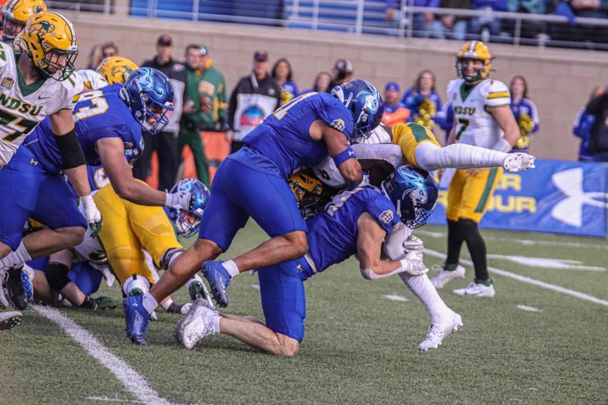Colby Huerter and Jason Freeman tackle a Bison ball carrier in their 33-16 win against NDSU on Nov. 4, 2023