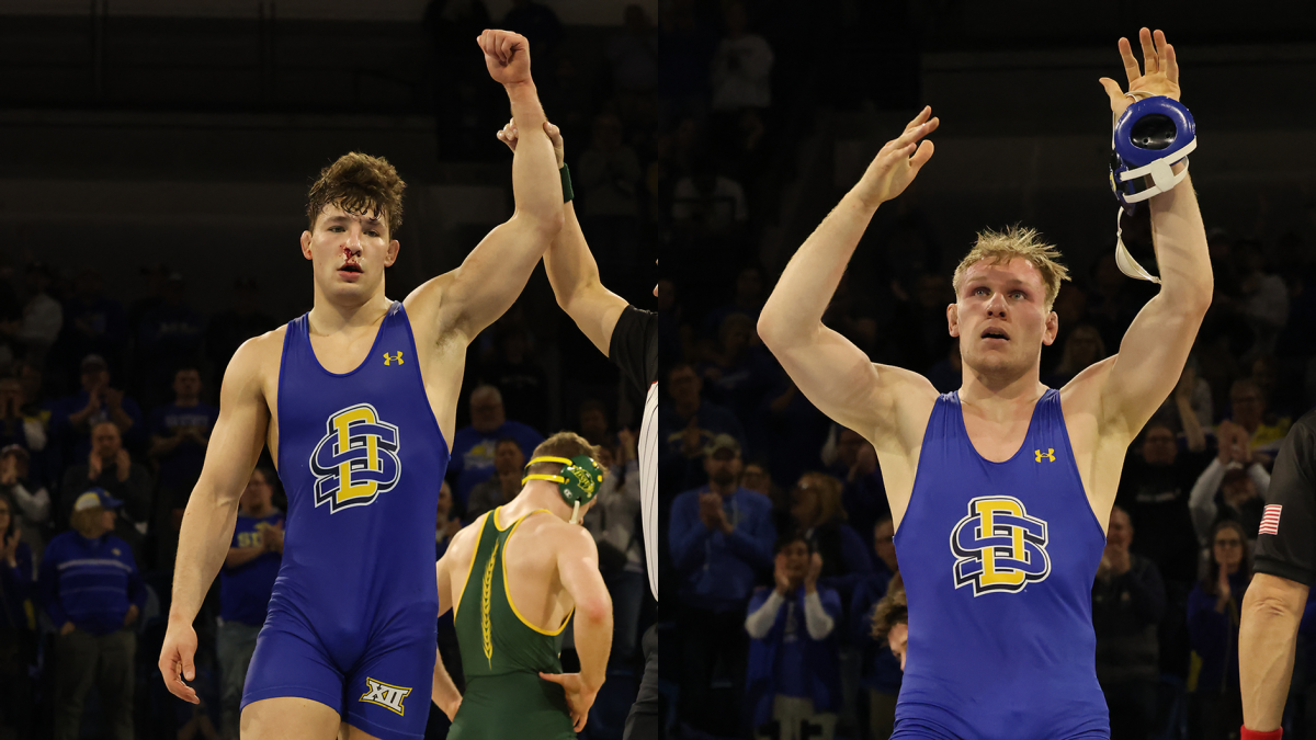 Cade+DeVos+and+Tanner+Sloan+get+their+hands+raised+after+winning+the+Big+12+Wrestling+Championship+at+174+and+197+pounds.+DeVos+defeated+Gaven+Sax+of+NDSU+6-4+and+Sloan+beat+Rocky+Elam+of+Missouri+1-0.