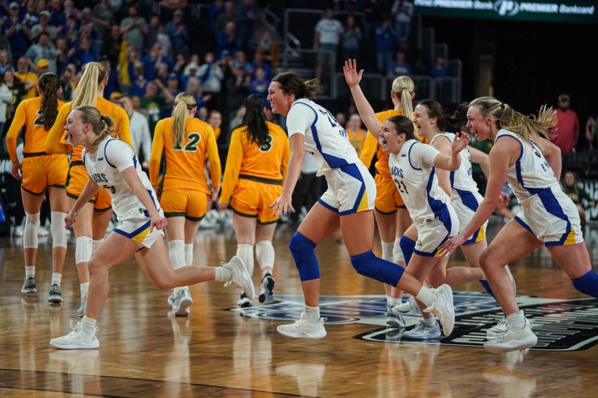 Left+to+right%3A+Ellie+Colbeck%2C+Mesa+Byom%2C+Paige+Meyer+and+Brooklyn+Meyer+charge+their+team+after+they+won+the+Summit+League+Tournament+against+NDSU+67-54.