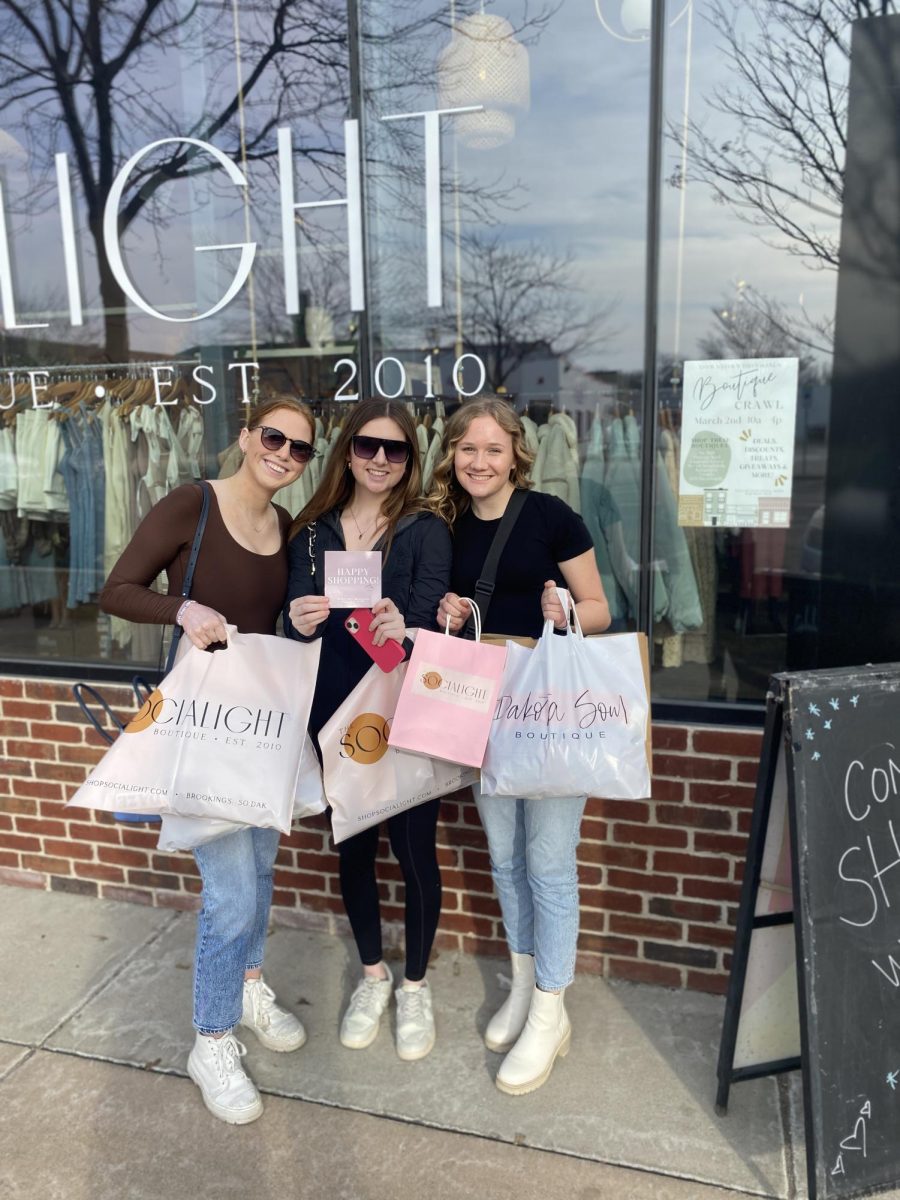 A group of happy shoppers proudly holding their haul they bought during the Brookings Boutique Crawl. The event was held March 2 and was a success for all the businesses involved.