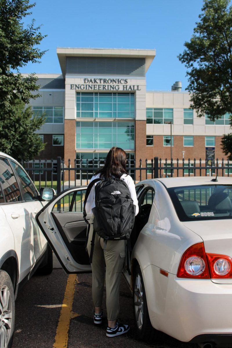 Lilly Krogman-Gibson navigates the crowded parking lot as students fill commuter lots and the new year begins.