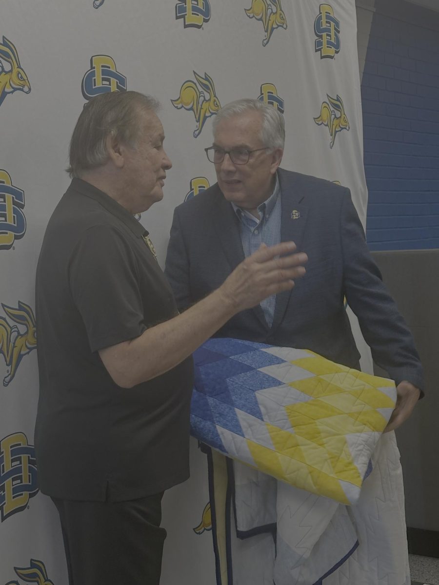 Olympic 10,000-meter run champion Billy Mills talks with SDSU President Barry Dunn last weekend during the Festival of Books