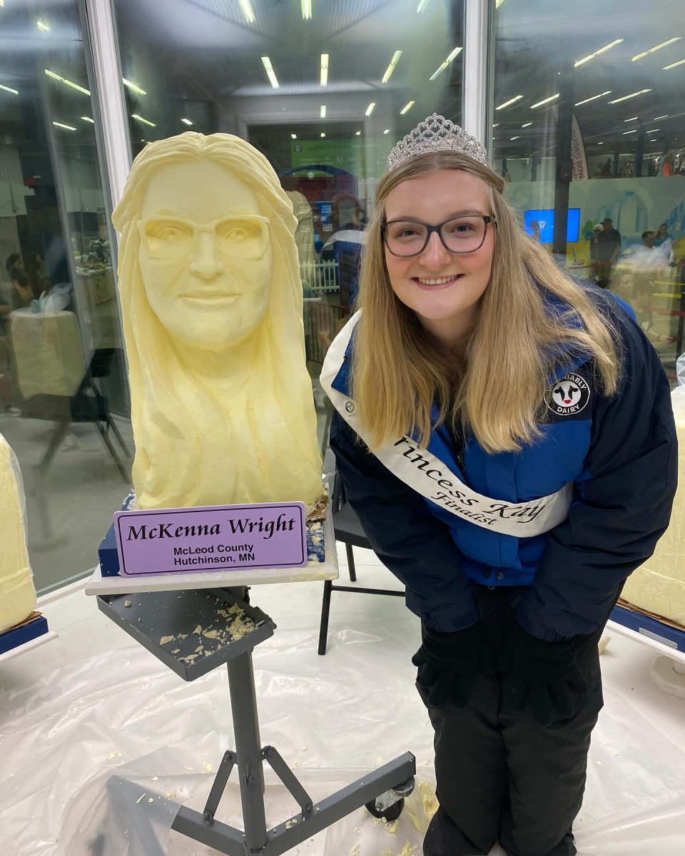 Princess Kay finalist McKenna Wright, an SDSU student, poses with a butter sculpture of herself.