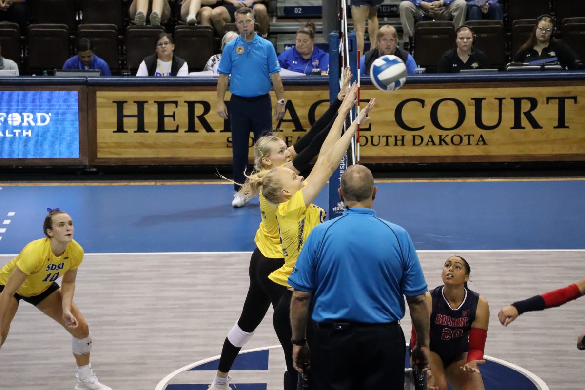 SDSU's Sydni Schetnan, left, and Annalee Ventling-Brown go up for a block on the right side during a match against Belmont on Saturday, Sept. 21, 2024 at the Sanford  Pentagon in Sioux Falls.