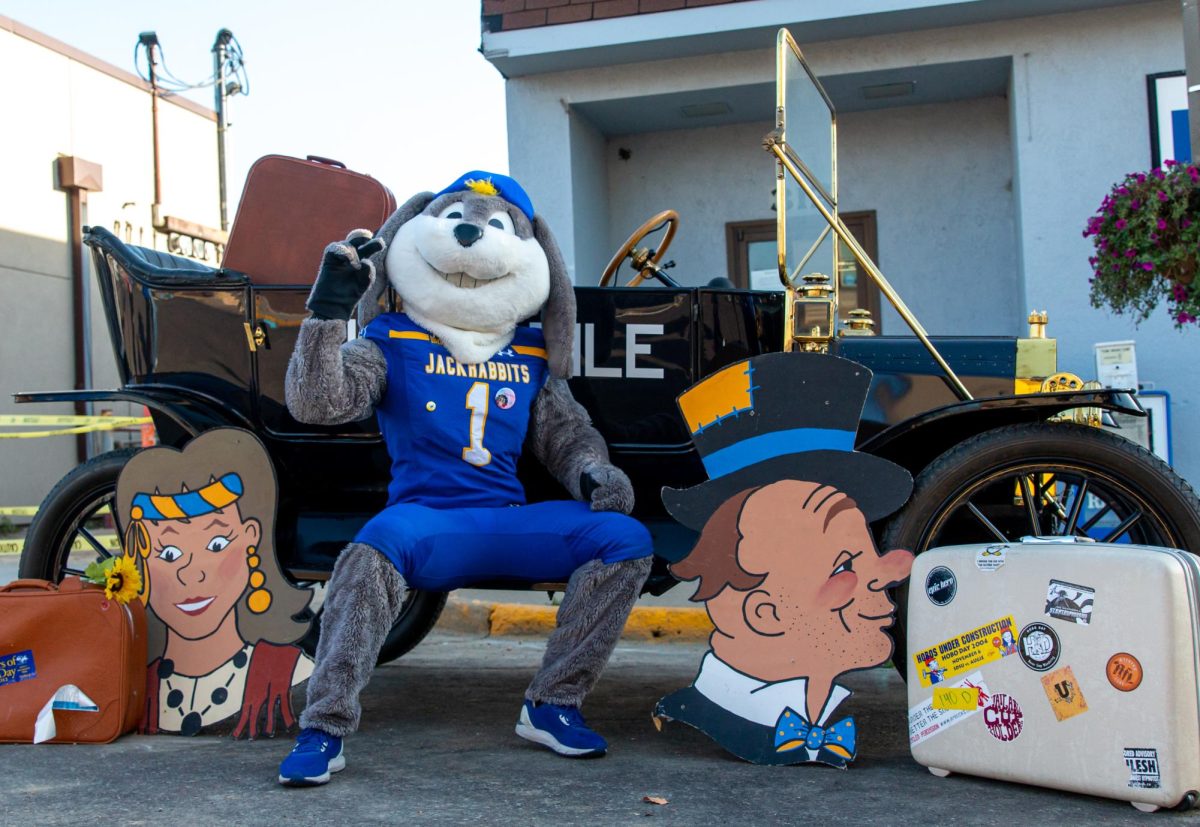 Jack, the SDSU mascot, poses for a photo in front of the Bummobile, at Rally of the Rails on Thursday, Oct. 12, 2023. 