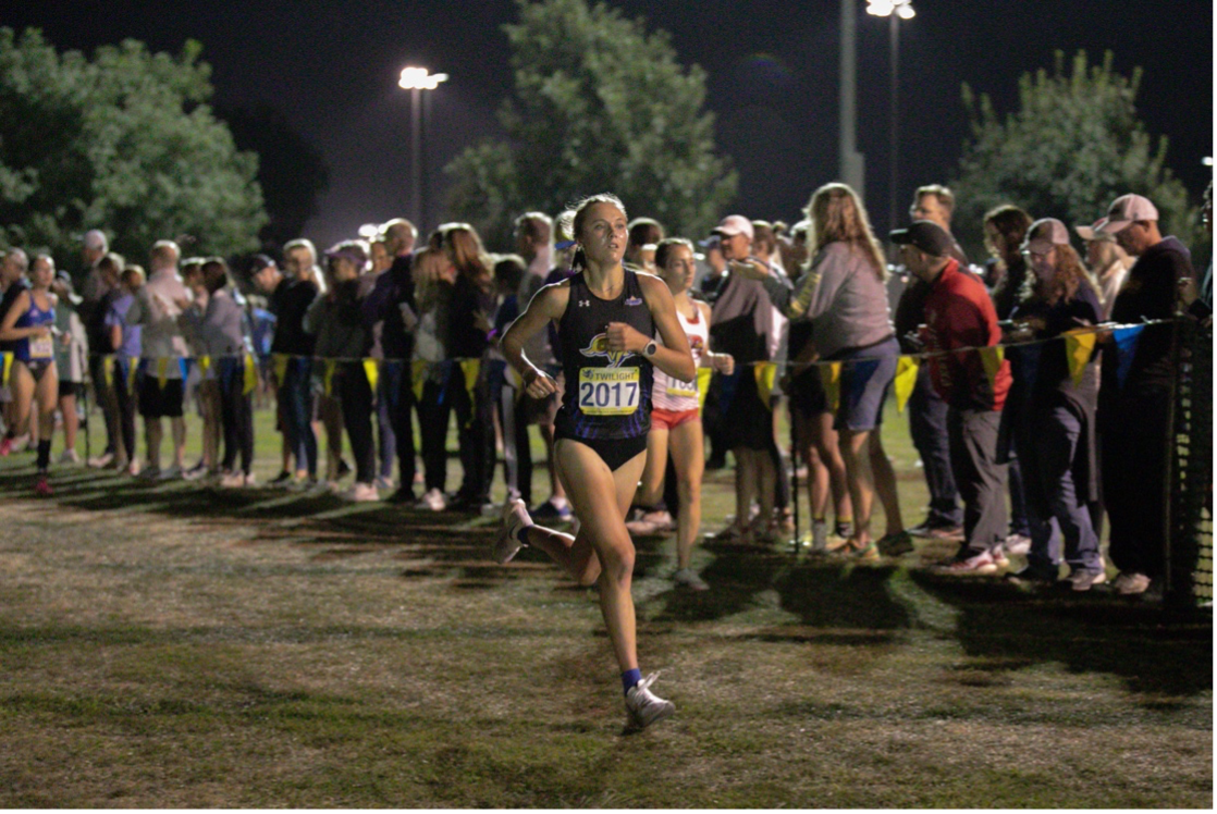 Meghan Ford running in the Augustana Twilight at Yankton Trails in Sioux Falls, South Dakota. This was her first meet as a South Dakota State Jackrabbit. Ford placed third in the race and helped South Dakota State placed second out of 20 teams that competed in the race.