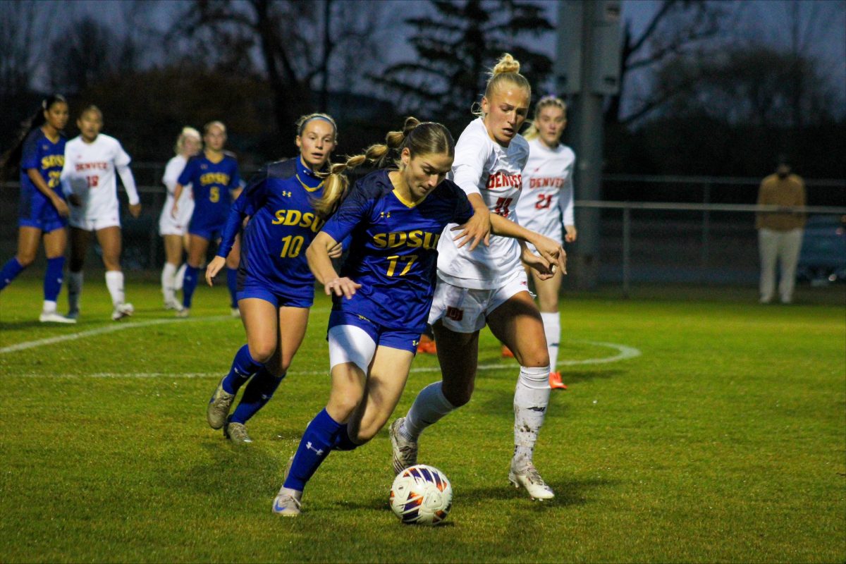 Katherine Jones running over a Denver player in their last loss of 
Summit League conference play.