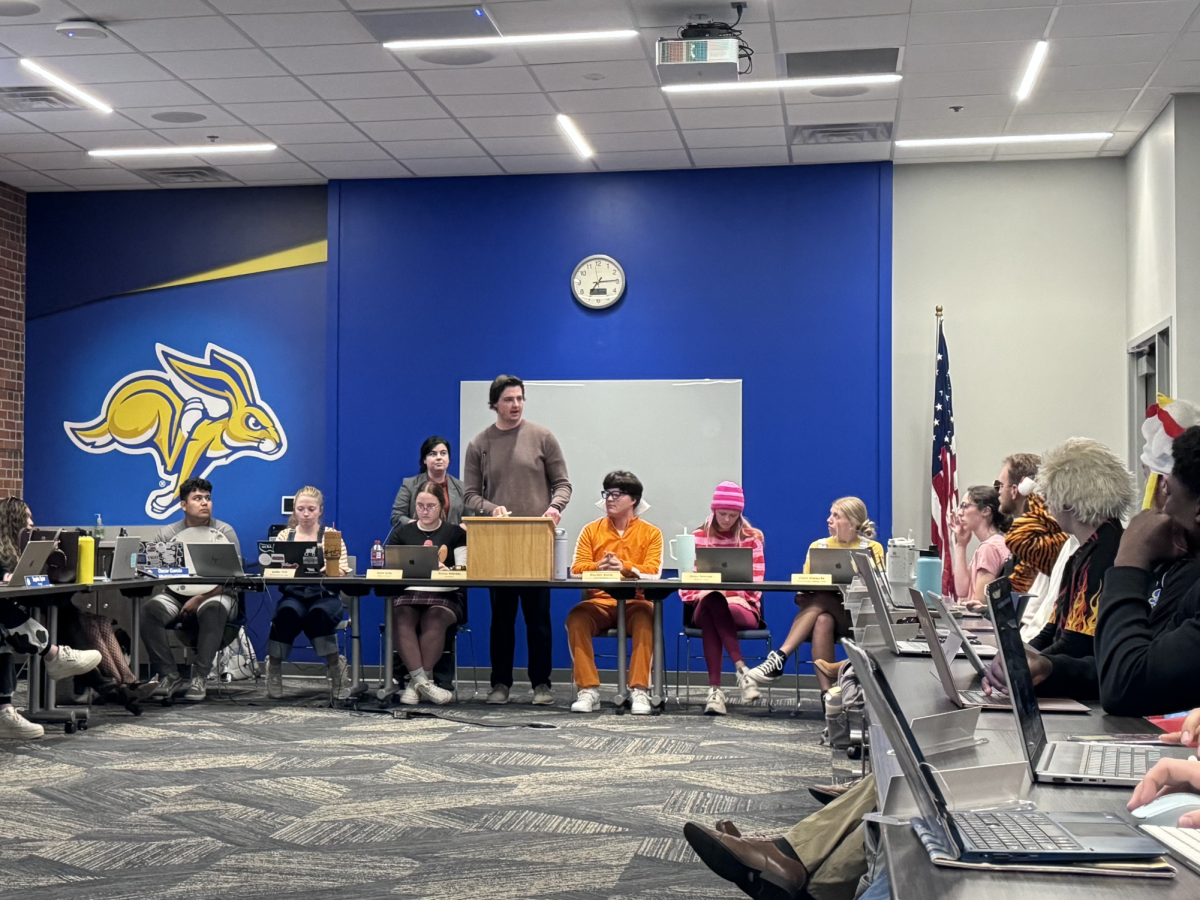 City Representatives Andrew Rasmussen and Brianna Doran inform a festive Students’ Association about the new budget.