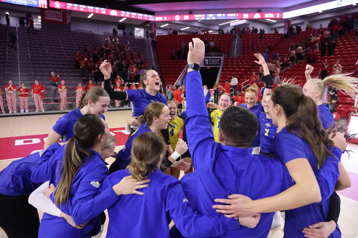 The Jackrabbit volleyball team celebrates after sweeping rival South Dakota to earn the outright Summit League crown on Monday, Nov. 19 in Vermillion.